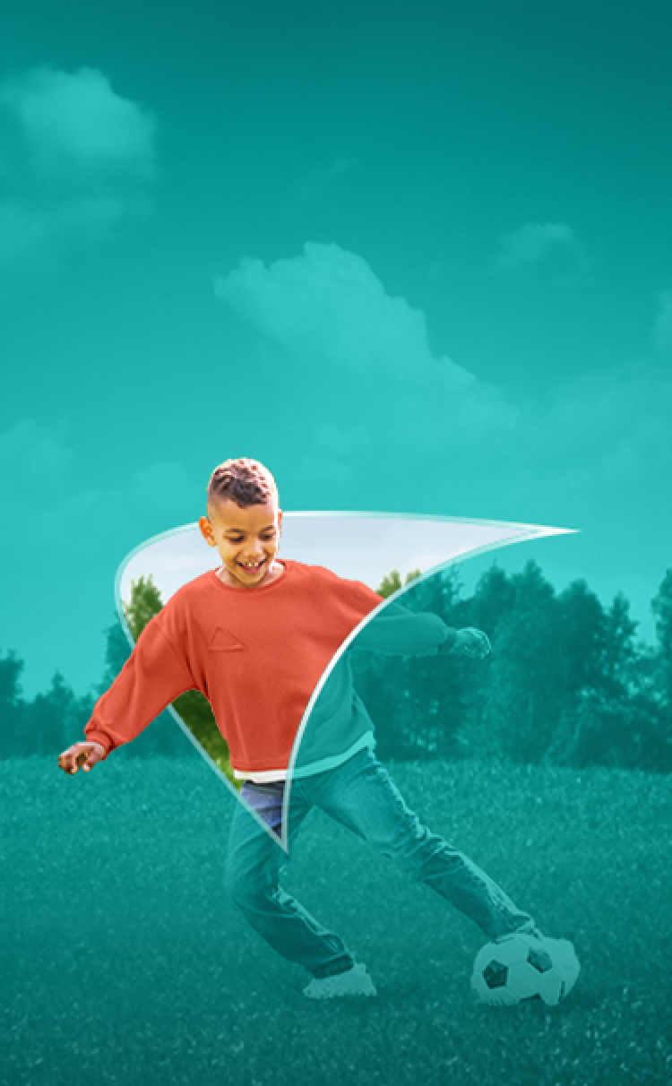 Picture of a young boy playing, kicking a soccer ball. A liver shape appears behind him.